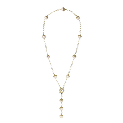 Gold-plated lariat necklace with baroque pearls and textured caps on cream background, showing adjustable Y-shaped design.