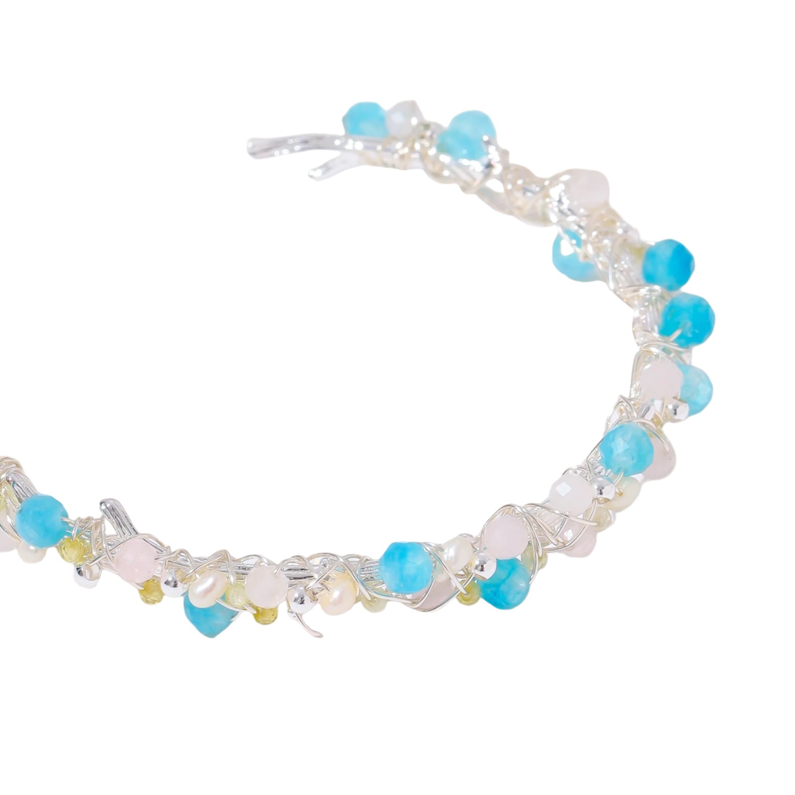 Delicate wire-wrapped bracelet featuring turquoise, rose quartz, freshwater pearls, and zircon on a white background.
