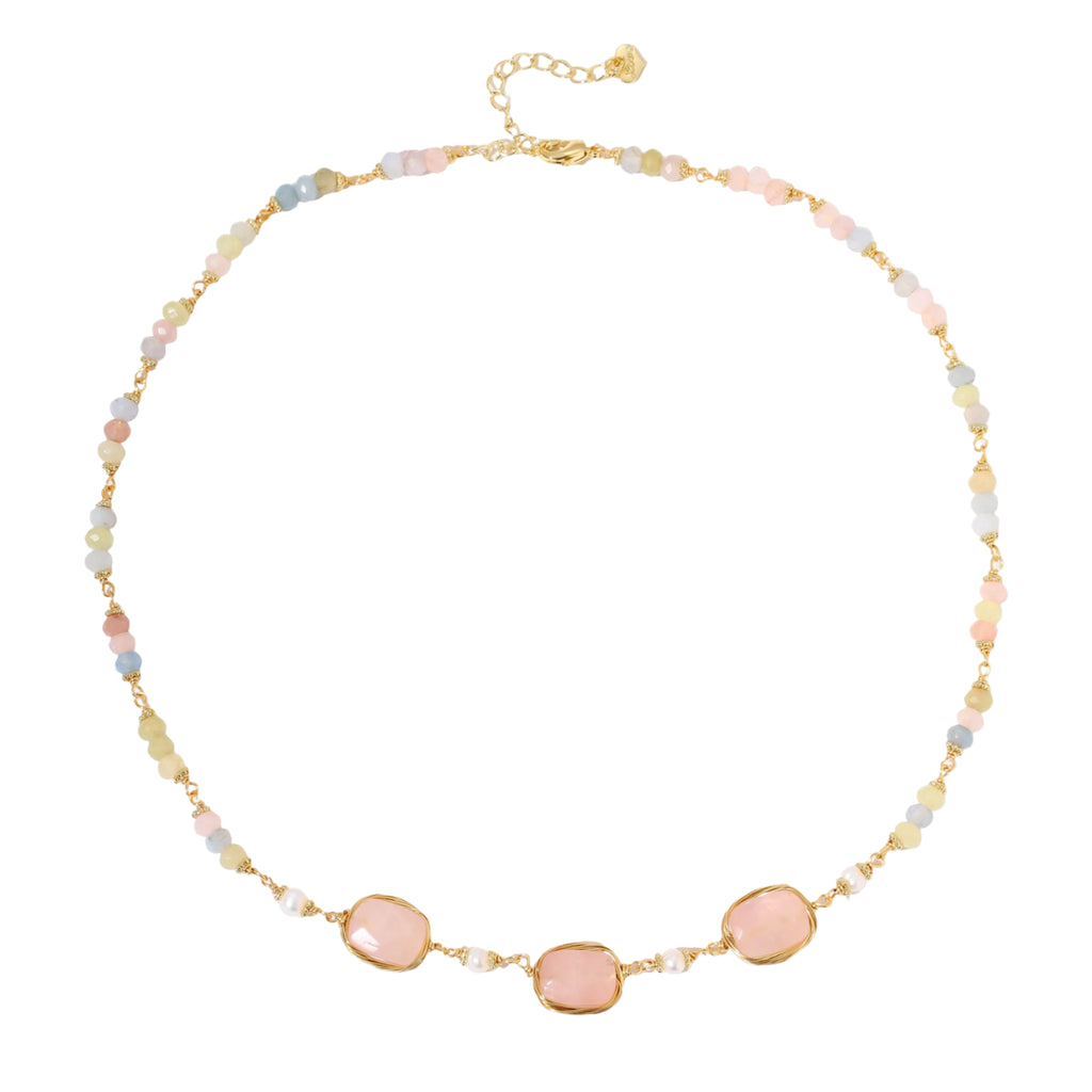 Gold necklace with three rose quartz stones, multicolor pastel beads, and pearl accents on white background.