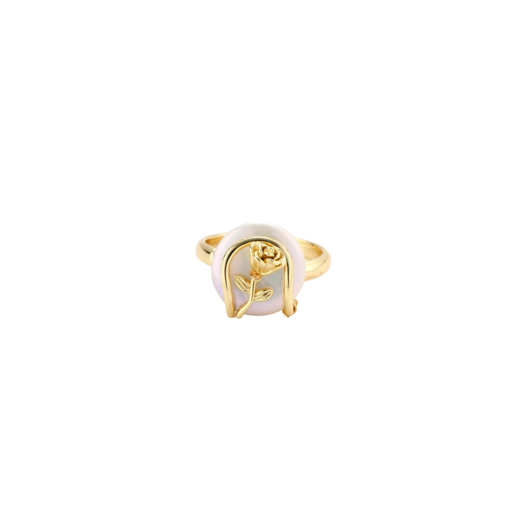 Gold-plated sculptural ring featuring a baroque pearl wrapped in a delicate rose and vine cage design